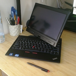 A black Lenovo ThinkPad with its screen slightly swiveled