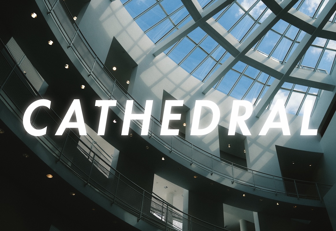 'Cathedral' zine cover featuring a full-page photo of a grand interior ceiling skylight in a modern museum. 'CATHEDRAL' is printed in large, capital, sans-serif, white, glowing letters.